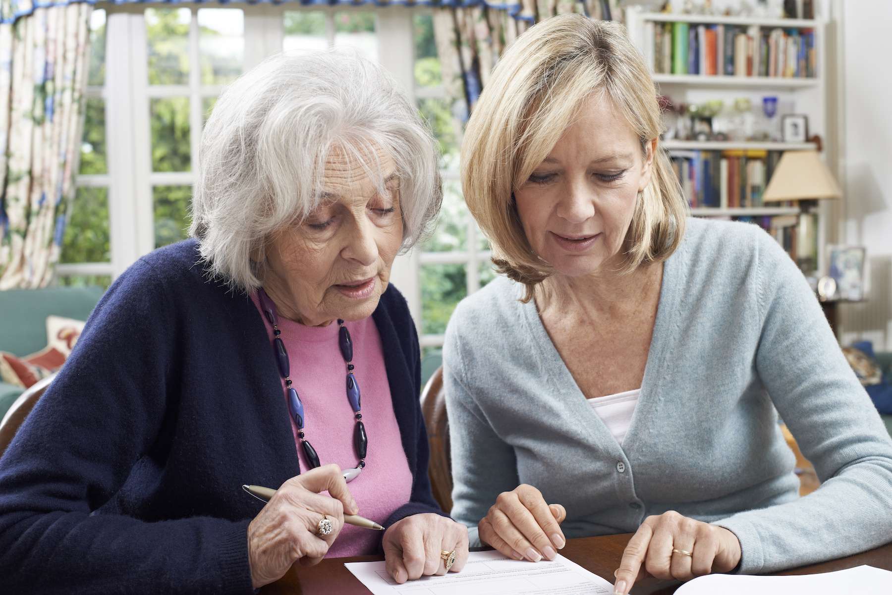 Caregiver helping senior with financial matters